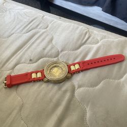 Watch with gold in the middle and red for outside color diamonds on the outside of the gold