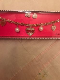 Guess charm bracelet and earrings