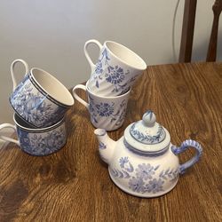 Four Coffee Cups And A Tea Pot