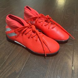 Red and grey Adidas Nemesis soccer cleats