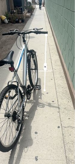 silver and blue Huffy Highland Mountain Bike