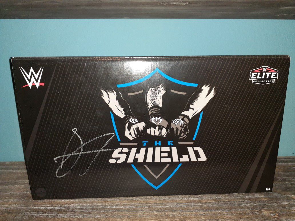 Signed Wwe shield action figures.