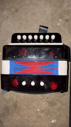 vintage child-sized black plastic toy accordion
