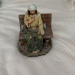 Jesus Figurine Sitting On A Bench 