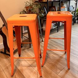Orange metal industrial stools