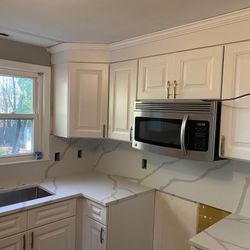 Kitchen Cabinets, Quartz Countertops, Vinyl Tiles.