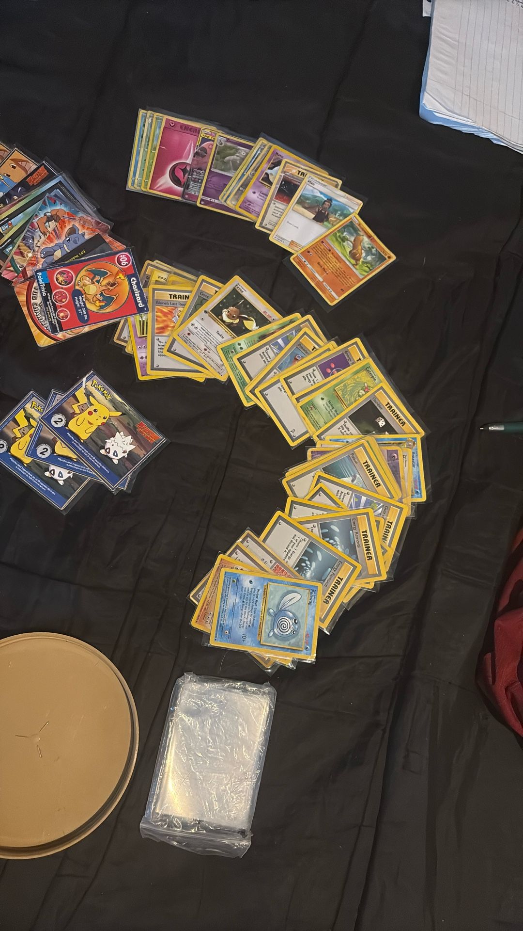 First year Pokémon cards, and trainer cards and also a stack of garbage pail kids cards