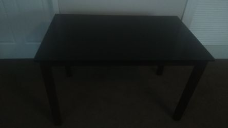 Small brown kitchen table without chairs