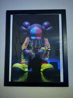 Kaws posters in frames