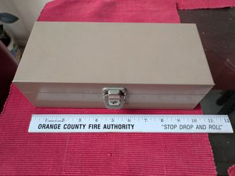 Sturdy metal box. Tan color