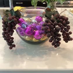 Glass bowl filled with 36 purple and gold ornaments, adorned with artificial grapes 8”T