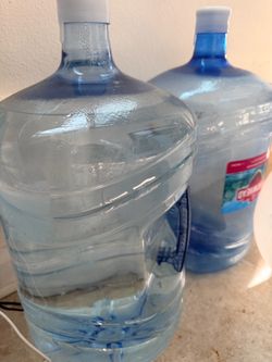 Two empty water bottles five gallons