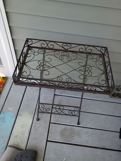 Black wrought iron table tray with glass insert.
