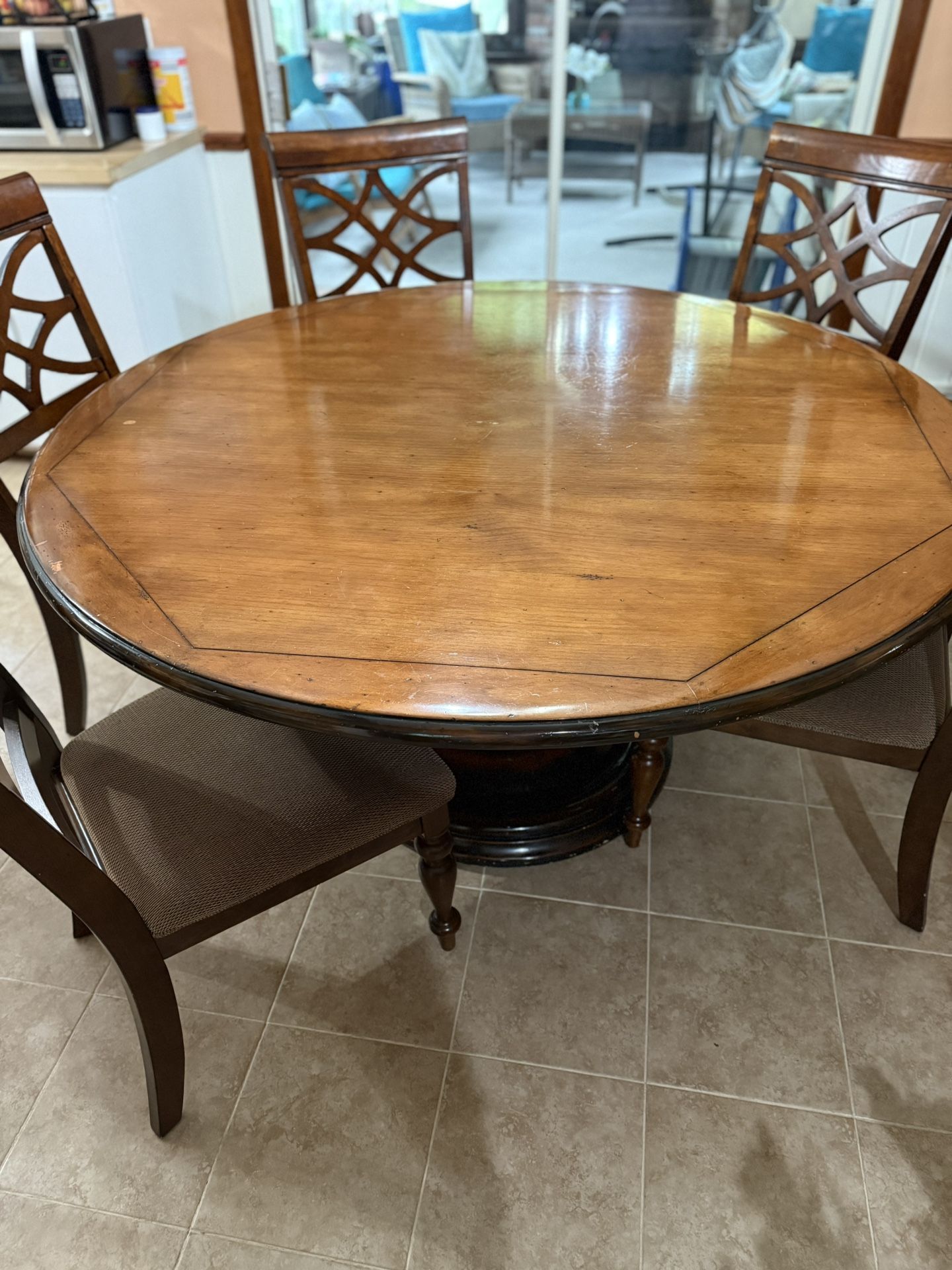 ATELIERS de la MADELEINE, solid wood pedestal dining table measuring L: 58" x W: 58" X H: 29". 