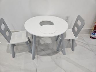 Round table with storage and two chairs