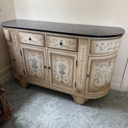 French country style sideboard by Stein World features hand-painted floral motifs and a dark wood top