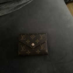 L.  V wallet with pink interior 