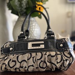 Guess shoulder bag with a black snakeskin-embossed section and a beige canvas body 