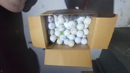 Assorted used golf balls. Random names and conditions.