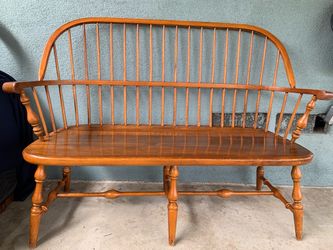 a mid-20th century Ethan Allen solid maple Windsor settee.