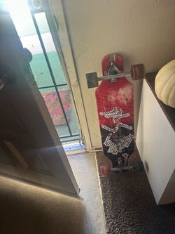 Red Longboard Skateboard with Stickers