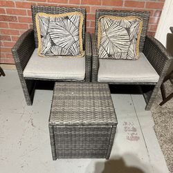 Two wicker chairs and ottoman