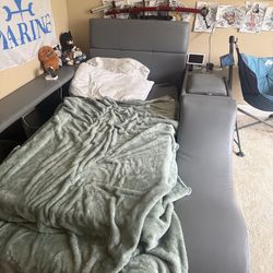 Grey twin bed with storage on side