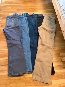 All 5 pairs of men's jeans, Levi’s and Carhartt size 34x34.