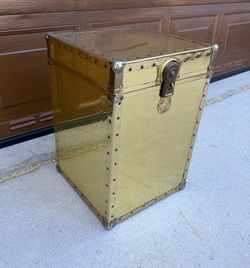 Vintage brass storage trunk from the 1970s; typically shows signs of wear and scratches. No key included; opens with a screwdriver.