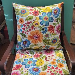 Wooden chair with new floral cushions that are interchangeable 