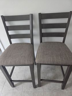 Two grayish high chairs