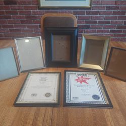 Assorted picture frames, including certificate frames