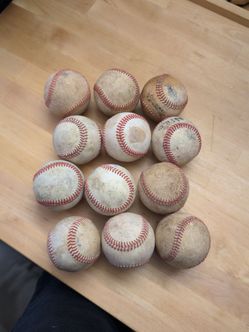 One dozen used baseballs
