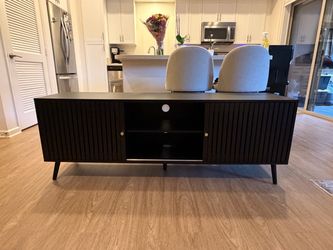 Black mid-century modern slatted door TV stand