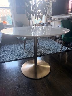 CB2 brass bass lacquered dining table