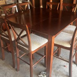 Pub style dining room table with eight chairs