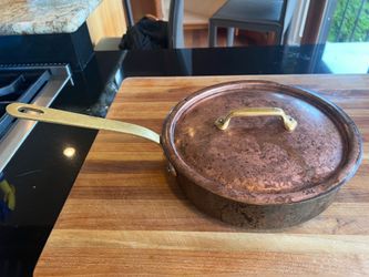 This is a vintage French copper sauté pan (sauteuse) complete with its matching copper lid. Given the heavy-duty construction and the distinctive shap