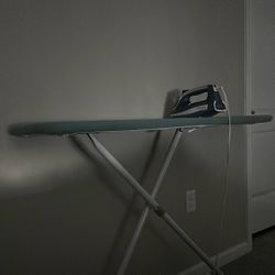Ironing board with a cover and an iron...