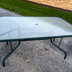 large heavy metal patio table. HOLDS 6 CHAIRS. BRING MUSCLE 