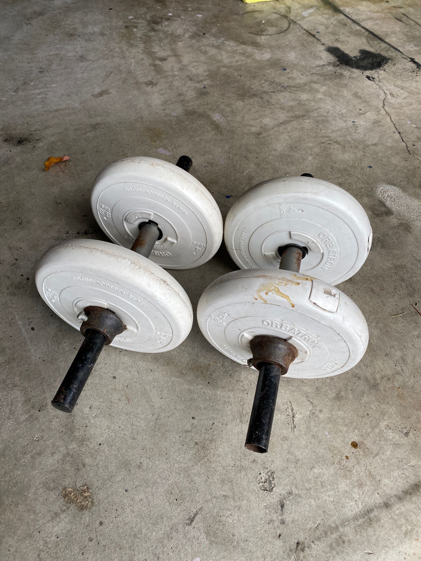Plastic/Cement weight, 1”olympic bar, 2 curl bars, 100lbs of weights