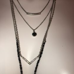 New 19” long 4 strands sliver necklace with black beads, rhinestones, a silver slider charm, a black stone charm, and a gorgeous tassel charm at the