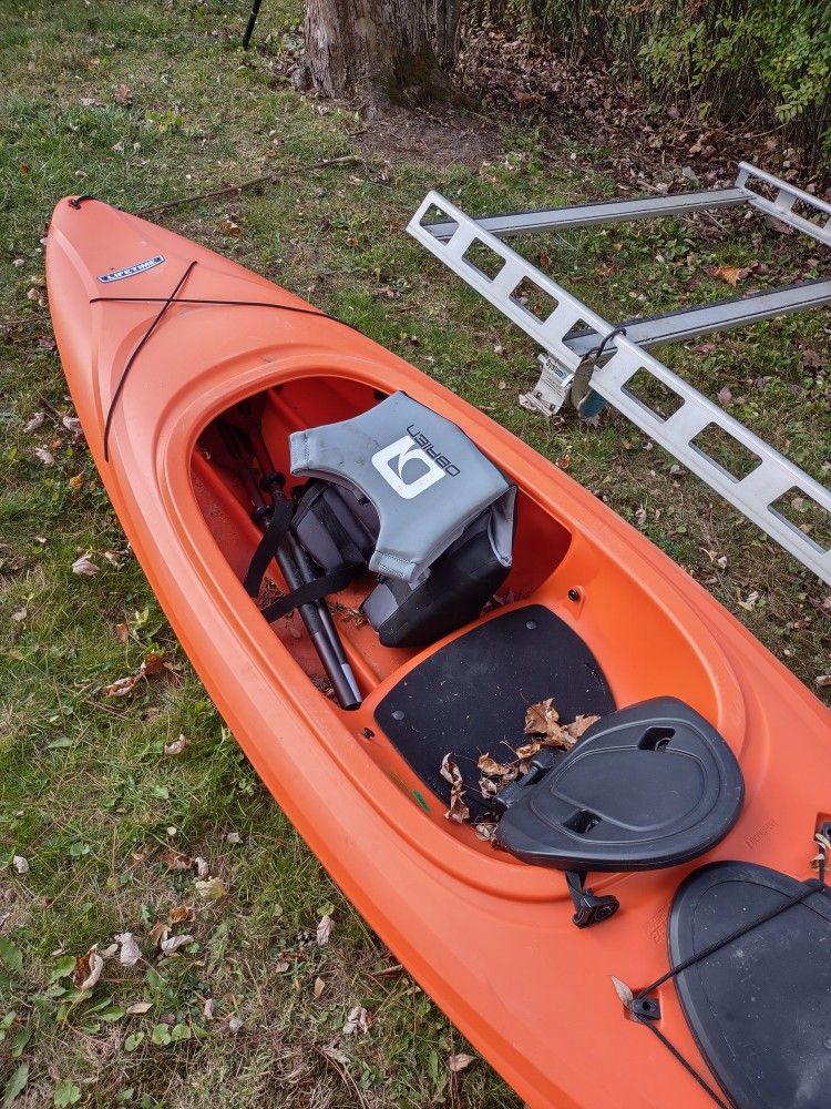Kayak With Paddles and Life Jacket