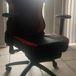 reclining gaming chair, desk, and monitor