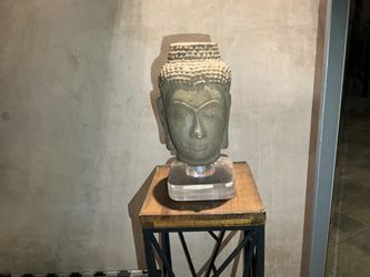 Sandstone head of Buddha on plexiglass stand