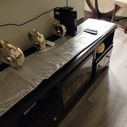 brown leather couches and round table and chimney