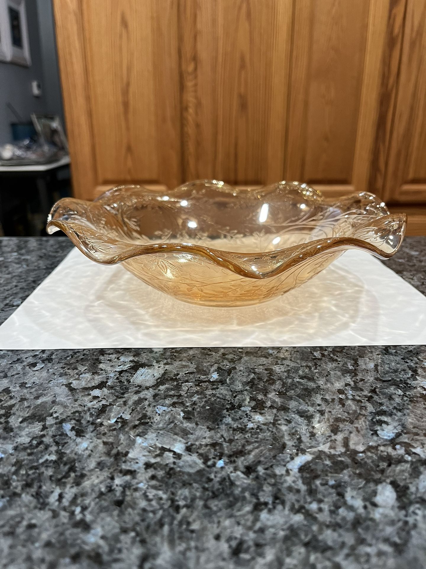 Vintage Depression glass Light Marigold Iridescent Carnival Glass Dish. With a floral design, pattern scalloped / Ruffle top around the edges.
