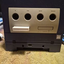 Indigo Nintendo GameCube with a Game Boy Player attached to the bottom.