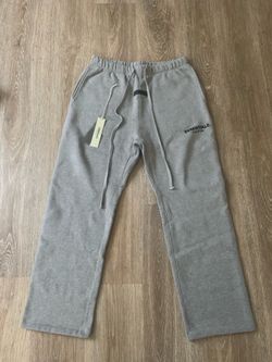 The highlighted item features the Fear of God Essentials Relaxed Sweatpants in the 'Dark Oatmeal' colorway, originally released as part of their Sprin
