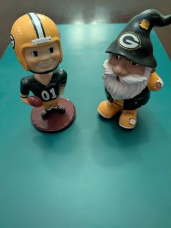 Green Bay Packers themed collectibles featuring a football player bobblehead and a team gnome