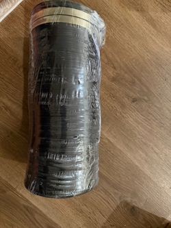 Stack of Black Plastic Trays Wrapped